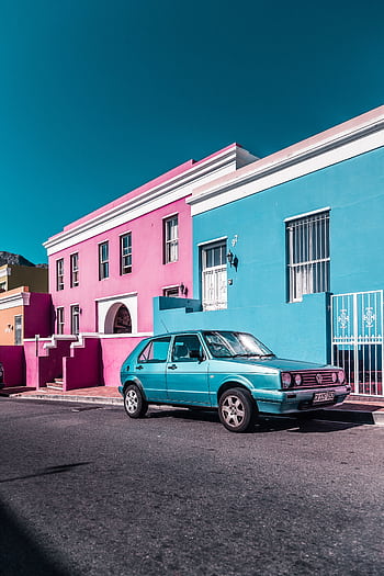 Classic car parked in Bo-Kaap, Cape Town, showcasing vibrant architecture and culture. HD phone wallpaper