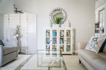 Bright living room with modern decor, featuring a glass table, plush sofas, and decorative elements in Austin, TX. HD wallpaper