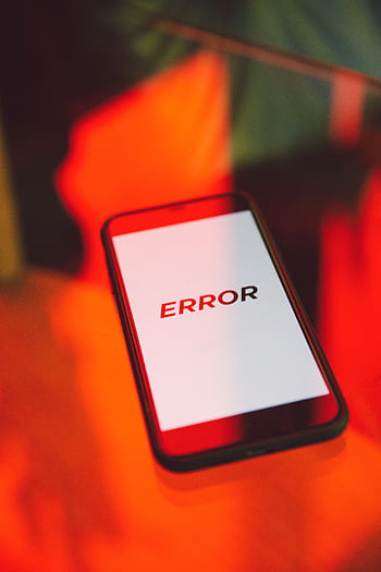 A close-up view of a smart showing an error message against a vibrant red background, symbolizing tech issues. HD phone wallpaper