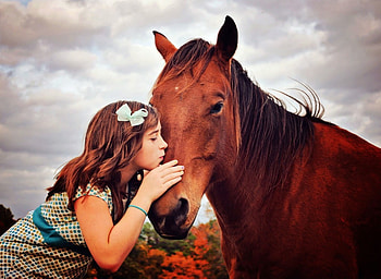 Innocent kiss, softness, tenderness, horse, best friends, childhood, brown horse, dress, touch, forever friends, beautiful moments, happiness, little girl, magic, ribbon, sweet moments, love, clouds, sky, friendship, kiss, hair HD wallpaper