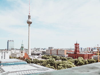 A breathtaking daytime aerial shot of Berlin featuring the Fernsehturm and vibrant architecture. HD wallpaper