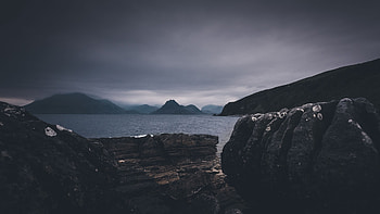 Stones Rocks Ocean Background And Landscape View Of Mountains With Fog Under Sky During Nighttime Nature HD wallpaper