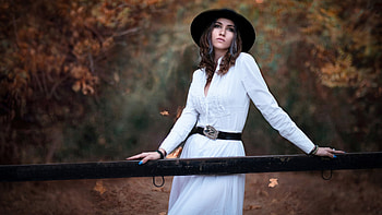 Beautiful Girl Model Is Standing In Blur Forest Background Wearing White Dress And Black Hat Nature HD wallpaper