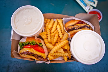 Delicious cheeseburger meal with crinkle-cut fries and drinks, perfect for a quick lunch or fast food craving. HD wallpaper