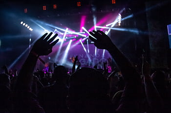 A vibrant night concert scene with a lively crowd enjoying the show in São Paulo, Brazil. HD wallpaper