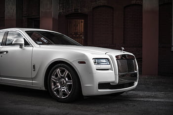 Elegant white Rolls Royce Ghost parked in a stylish urban backdrop, showcasing luxury and design. HD wallpaper
