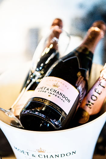 Close-up of Moët & Chandon Champagne bottles in an ice bucket, epitomizing luxury and celebration. HD phone wallpaper