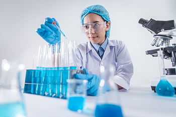 A female scientist using lab equipment for research in a modern laboratory setting. HD wallpaper