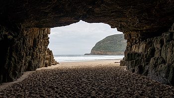 Beach Sand Rock Cave Greenery Mountain Ocean Waves Blue Sky Background Nature HD wallpaper