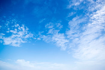 A serene view of a bright blue sky with fluffy white clouds, perfect for backgrounds. HD wallpaper
