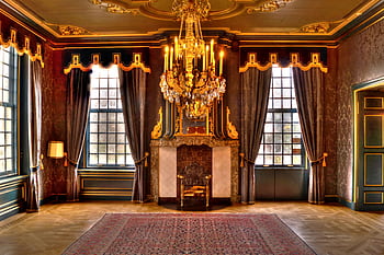 Opulent palace living room featuring a grand golden chandelier and elaborate interior design. HD wallpaper