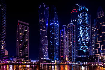Illuminated skyscrapers of Dubai Marina at night, reflecting on the water. HD wallpaper