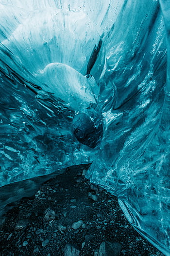 A mesmerizing view of frozen blue ice cave formations capturing nature's artistry. HD phone wallpaper