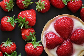 Top view of fresh strawberries and a delicious cream tart, emphasizing freshness and sweetness. HD wallpaper