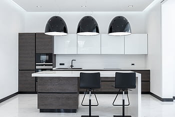 Spacious and stylish modern kitchen with sleek lighting and furnishings. HD wallpaper