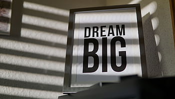 Framed motivational 'Dream Big' text art creates an inspiring indoor ambiance. HD wallpaper