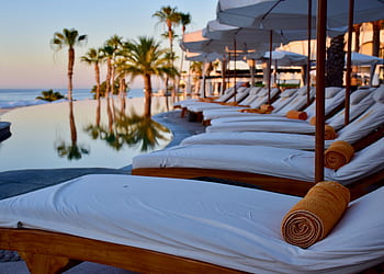 Experience luxury relaxation at a poolside resort in Cabo San Lucas, Mexico. HD wallpaper