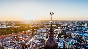Stunning aerial view of Riga, Latvia with the sun rising over the historic cityscape and skyline. HD wallpaper