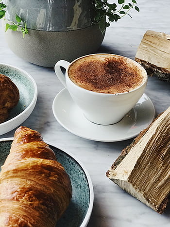 Close-up of a steaming cappuccino with a golden croissant, perfect for a cozy morning. HD phone wallpaper
