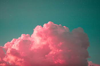 A stunning display of vibrant pink clouds set against a teal sky during twilight, creating a dreamy atmosphere. HD wallpaper