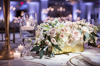 Luxurious wedding table setting with roses and candles, creating a romantic ambiance. HD wallpaper