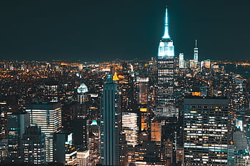 A breathtaking view of New York City's illuminated skyline at night. HD wallpaper