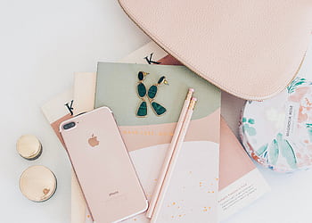 A stylish flatlay featuring rose gold accessories, an , and a notebook, perfect for a feminine fashion theme. HD wallpaper