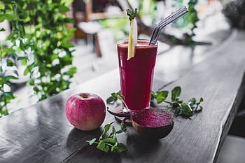 Refreshing beetroot and apple juice garnished with mint leaves, perfect for a healthy detox. HD wallpaper