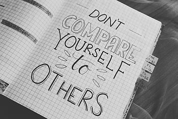 Black and white with motivational handwriting on a grid notebook page. HD wallpaper