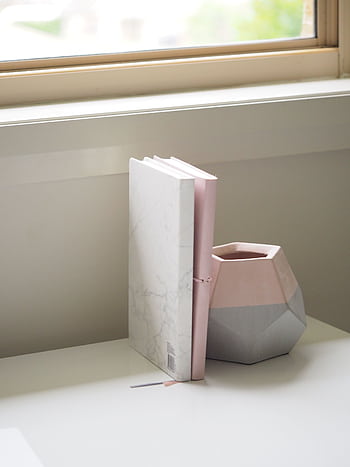 Simple and elegant desk scene featuring a marble notebook and a geometric vase by a window. HD phone wallpaper