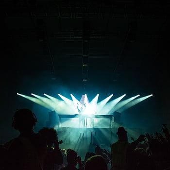 DJ electrifying the club with vibrant lights and energetic beats, captivating the lively crowd. HD phone wallpaper