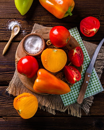 Colorful tomatoes and peppers on a rustic wooden table with salt and knife. HD phone wallpaper