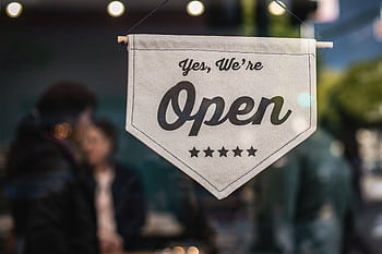 Welcoming open sign displayed in a shop window with blurred background. HD wallpaper