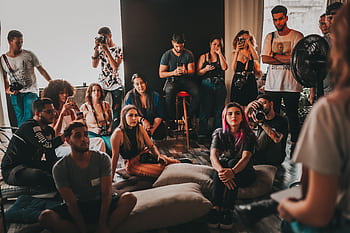 A diverse group gathered in a São Paulo studio for a casual discussion and graphy session. HD wallpaper