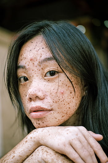 Intimate portrait highlighting the unique freckles and natural beauty of a young woman. HD phone wallpaper