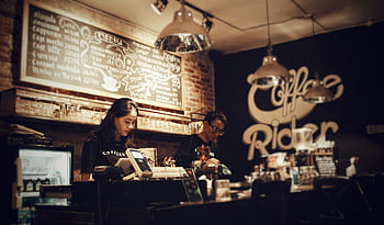 Baristas preparing coffee at Coffee Rider, Karawaci. Cozy indoor setting with menu board. HD wallpaper