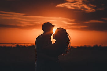 Romantic silhouette of a couple embracing at sunset, ideal for love and romance themes. HD wallpaper