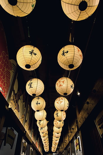 Rows of traditional Japanese paper lanterns glowing warmly in the night. HD phone wallpaper