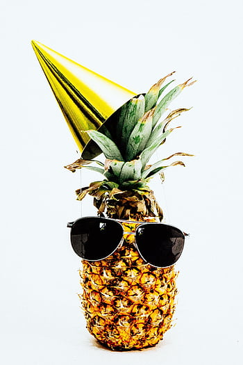 A pineapple dressed in sunglasses and a party hat, exuding a fun and tropical vibe. HD phone wallpaper