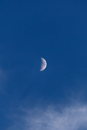 A serene crescent moon in a clear blue sky, perfect for backgrounds. HD phone wallpaper