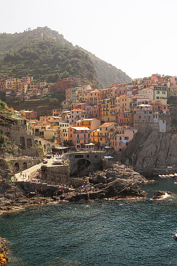 Explore the vibrant clifftop village of Cinque Terre, Italy, showcasing its colorful architecture and stunning coastal views. HD phone wallpaper