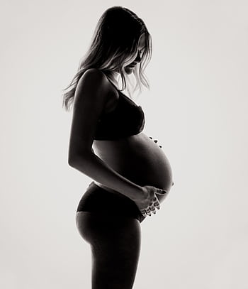Silhouette of a pregnant woman in lingerie, expressing motherhood and contemplation. HD phone wallpaper