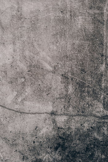 Close-up of a weathered concrete wall with intricate texture, ideal for backgrounds. HD phone wallpaper