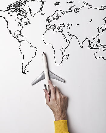 A person holds a toy plane above a drawn world map, symbolizing global travel. HD phone wallpaper