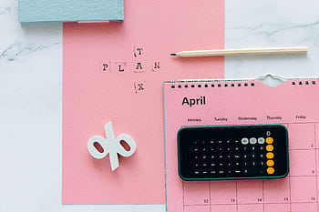 Flat lay of April calendar with calculator, pencil, and pink background for financial planning. HD wallpaper