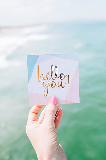 A vibrant greeting card with 'hello you!' against a seaside backdrop, conveying positivity. HD phone wallpaper