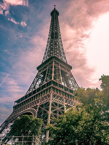 Stunning view of the Eiffel Tower under a colorful sky, symbolizing Parisian architecture. HD phone wallpaper