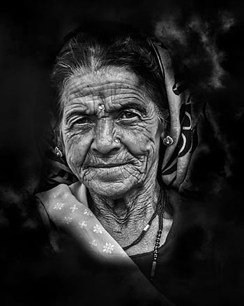 Black and white portrait capturing the wisdom and grace of an elderly Indian woman with expressive wrinkles and traditional attire. HD phone wallpaper