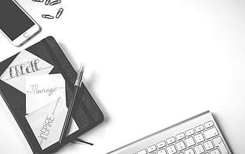 Minimalist flat lay of an office desk with notebook, keyboard, and smart. HD wallpaper