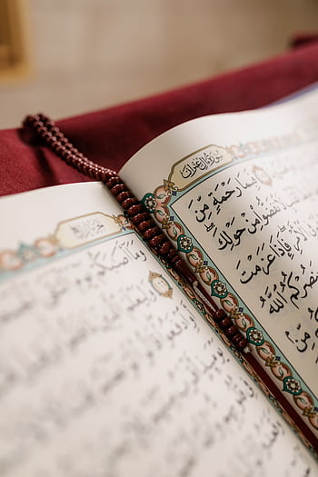 Detailed of an open Quran with prayer beads, symbolizing Muslim culture and spirituality. HD phone wallpaper